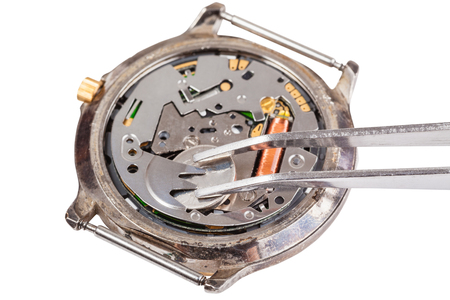 Repairing of watch - replacing battery in quartz watch isolated on white backgroundの写真素材