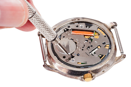 Repairing of watch - watch repairer replaces battery in quartz wristwatch isolated on white backgroundの写真素材