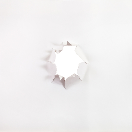 front view of sheet of paper with rough punched holeの写真素材