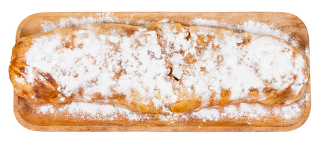 top view of whole apple strudel pie on wooden board isolated on white backgroundの写真素材