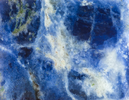 blue and whte background from surface of Sodalite natural mineral gem stone
