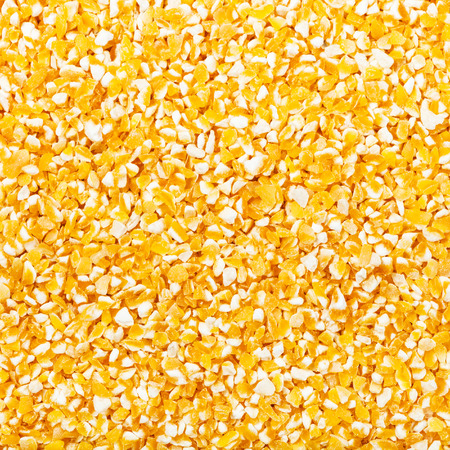 square food background - raw ground corn groats close upの写真素材