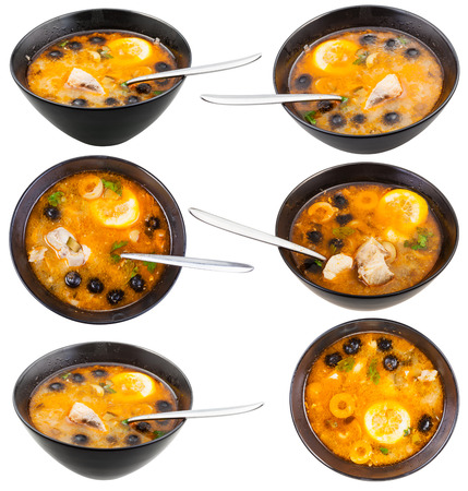 set of bowls with Solyanka russian traditional spicy and sour soup with fish isolated on white backgroundの写真素材