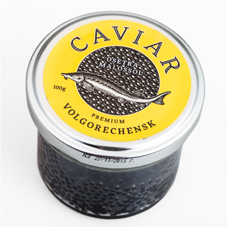 MOSCOW, RUSSIA - JANUARY 16, 2016: glass jar covered by yellow lid with russian black sturgeon caviar on white background. The main place of production of black caviar is the Caspian Sea.のeditorial素材