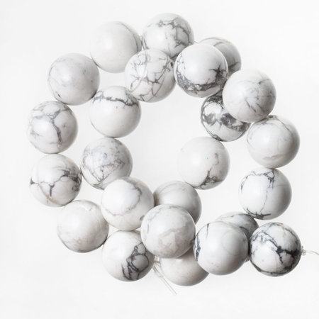 tangled necklace from white Howlite gemstone beads on white backgroundの写真素材