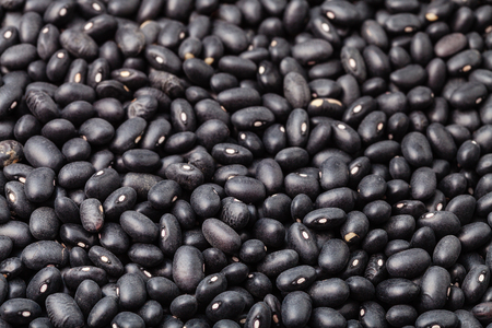 many scattered raw Black turtle beans on surfaceの写真素材