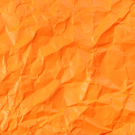 square background from orange colour crumpled paperの写真素材