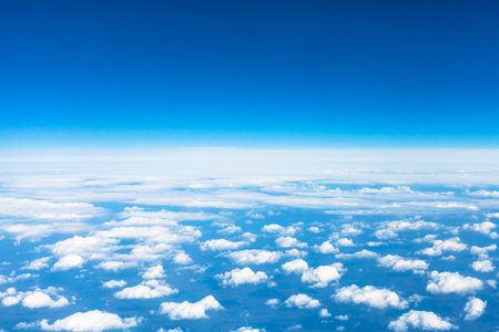 above view many little clouds in blue sky from aircraft