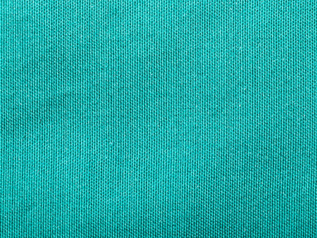 textile background - silk green Taffeta cloth with weave pattern of threads close up