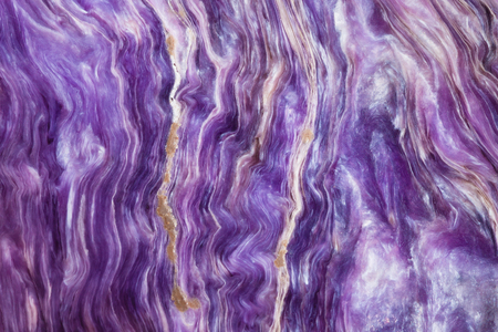 macro shooting of natural mineral stone - background from polished charoite gemstoneの写真素材