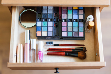 above view of cosmetic set in open drawer of nightstandの写真素材