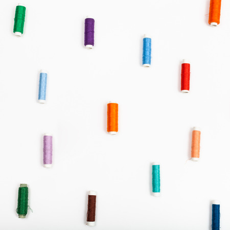 several spools of sewing thread on white backgroundの写真素材