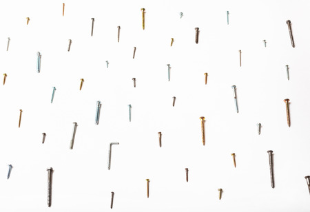 side view of many wood screws and self-tapping screws arranged on white backgroundの写真素材