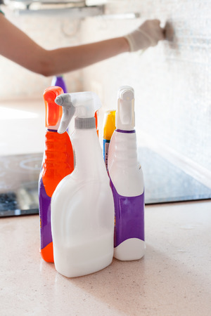 House cleaning - plastic bottles with detergents on kitchen tabletopの写真素材