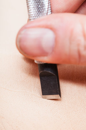 leathercrafting - blade of swivel knife cut leather surface close up