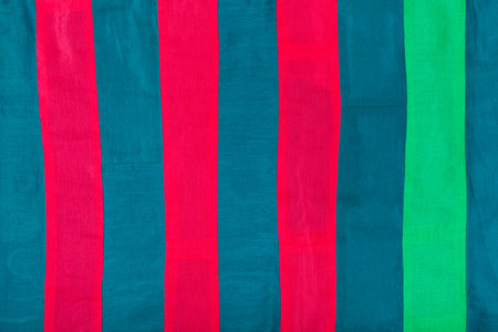 textile background - striped silk cloth with red, blue, green stripes