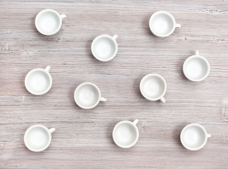 food concept - top view of many white cups on gray brown tableの写真素材