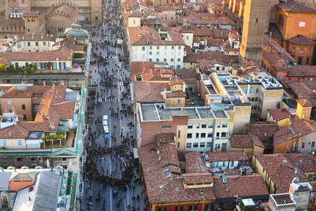 travel to Italy - above view of street with crowd of people and houses in Bologna city from Torre Asinelli ( Asinelli Tower) in eveningの写真素材