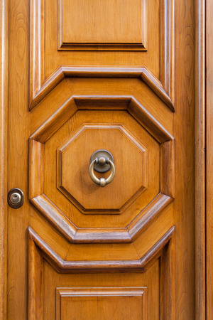 travel to Italy - old wooden door with brass door knocker in Rome cityの写真素材
