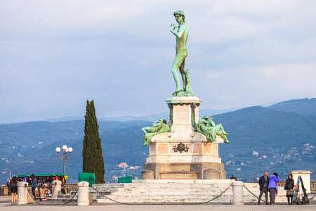 FLORENCE, ITALY - NOVEMBER 4, 2016: tourists near Bronze statue of David facing Florence city at center of Piazzale Michelangelo. This square was designed by architect Giuseppe Poggi and built in 1869のeditorial素材
