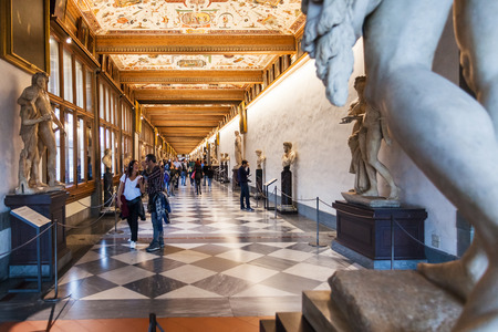 FLORENCE, ITALY - NOVEMBER 5, 2016: tourists in hallway of Uffizi Gallery. The Uffizi is one of the oldest museums in Europe, its origin refers to 1560, when Vasari designed large palaceのeditorial素材