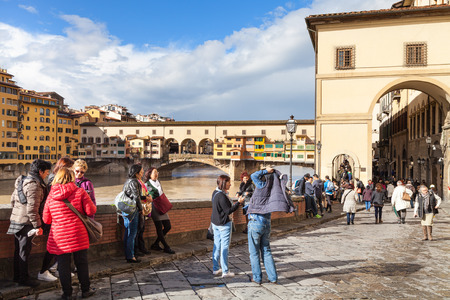 FLORENCE, ITALY - NOVEMBER 6, 2016: tourists near Vasari corridor and view of Ponte Vecchio in Florence. The Vasari Corridor connects Palazzo Vecchio with Palazzo Pitti, it was built in 1565のeditorial素材