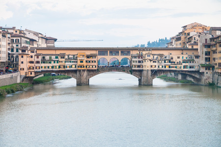 travel to Italy - view of Ponte Vecchio (Old Bridge) over Arno River in Florence city in evening twilightの写真素材