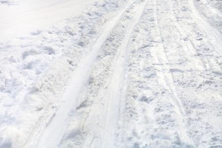 ski runs on snowy field in winter dayの写真素材