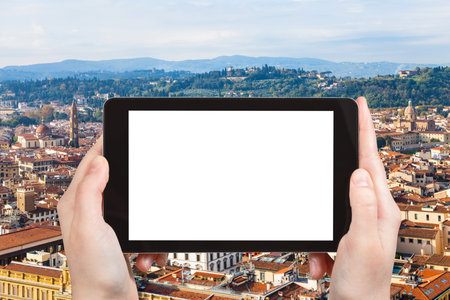 travel concept - tourist photographs Florence city on tablet with cut out screen with blank place...