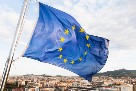 european union flag flutters above Barcelona cityの写真素材