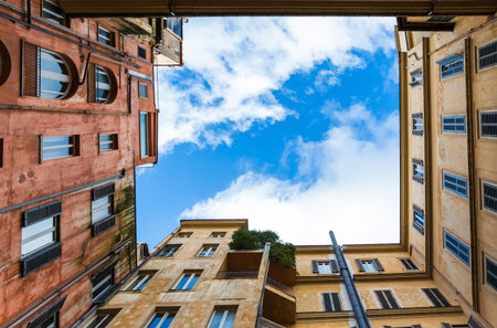 Travel to Italy - bottom view of cloudy sky from pation of urban house in Rome city in winter