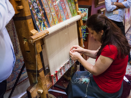 ISTANBUL, TURKEY - SEPTEMBER 13, 2010: Woman weave carpet in workshop. Carpet weaving is one of the ancient crafts in Turkey, and traditionally women have played a pivotal role in their creationのeditorial素材
