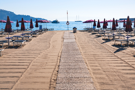 Italy - clean urban beach in giardini naxos town in Sicily in morningの写真素材