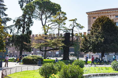 VERONA, ITALY - MARCH 29, 2017: tourists in garden on Piazza Bra in Verona in spring. Piazza Bra (The Bra) is the largest piazza in the cityのeditorial素材