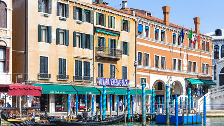 VENICE, ITALY - MARCH 30, 2017: people and gondolas near Rialto Bridge on Grand Canal in Venice. The city has about 50,000 tourists a day and only around 55,000 people reside in the historic townのeditorial素材