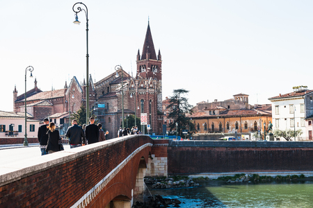 VERONA, ITALY - MARCH 27, 2017: people on bridge Ponte delle Navi and view of Chiesa di San Fermo Maggiore in Verona city. This medieval church hold relics of saints Fermo and Rusticoのeditorial素材