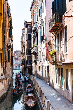 VENICE, ITALY - MARCH 30, 2017: tourists on gondolas in canal Rio dell'Albero . Number of gondoliers in Venice remains intact (their 425), and does not depend on whether the gondoliers go to retire.のeditorial素材