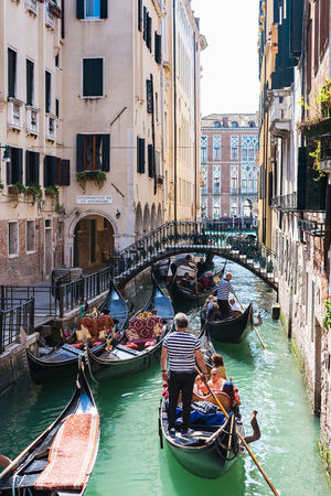 VENICE, ITALY - MARCH 30, 2017: people on gondolas in canal Rio rio de l'alboro. Number of gondoliers in Venice remains intact (their 425), and does not depend on whether the gondoliers go to retire.のeditorial素材
