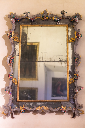 MANTUA, ITALY - MARCH 31, 2017: old mirror in Corte Vecchia of Ducal Palace Museum in Mantua city. Ducal Palace boasts more than 950 rooms and gardens, stores and cellars, courts and loggiasのeditorial素材