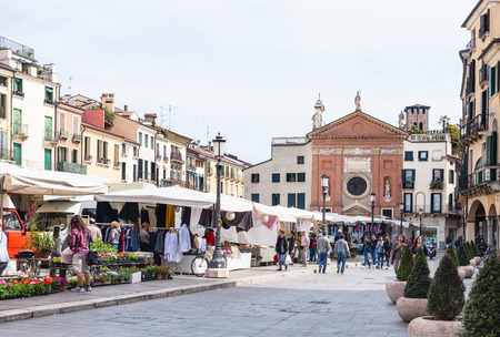 PADUA, ITALY - APRIL 1, 2017: people on street market on Piazza dei Signori near Church San Clemente in Padua. Church is mentioned in documents of 1190, was elevated to parish in fourteenth centuryのeditorial素材