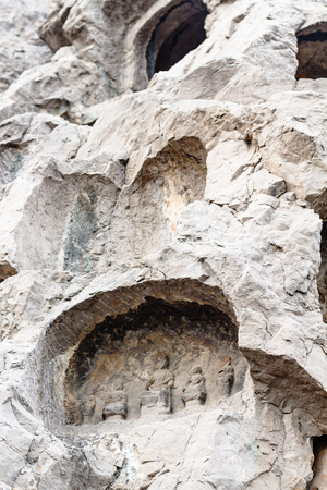 LUOYANG, CHINA - MARCH 20, 2017: caves with reliefs in Chinese Buddhist monument Longmen Grottoes (Longmen Caves). The complex was inscribed upon the UNESCO World Heritage List in 2000のeditorial素材