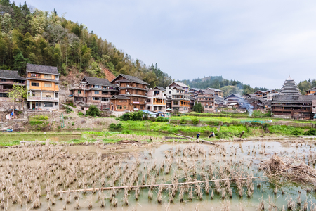 CHENGYANG, CHINA - MARCH 27, 2017: people near rice paddy in Chengyang village of Sanjiang Dong Autonomous County in spring. Chengyang includes eight villages of the Dong peopleのeditorial素材