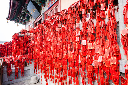 LUOYANG, CHINA - MARCH 20, 2017: red signs on Temple on East Hill of Chinese Buddhist monument Longmen Grottoes in spring. The complex was inscribed upon the UNESCO World Heritage List in 2000のeditorial素材