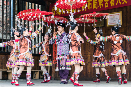 CHENGYANG, CHINA - MARCH 27, 2017: folk dancers in Culture Show on square of Folk Custom Centre of Chengyang village of Sanjiang County in spring. Chengyang includes eight villages of the Dong peopleのeditorial素材