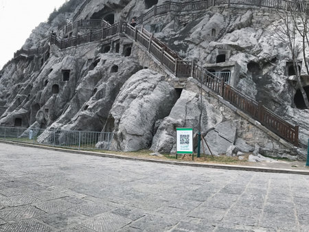 LUOYANG, CHINA - MARCH 20, 2017: carved caves in slope of West Hill in Chinese Buddhist monument Longmen Grottoes (Longmen Caves). The complex was inscribed upon the UNESCO World Heritage List in 2000のeditorial素材