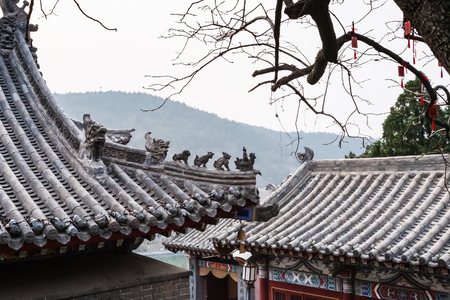 LUOYANG, CHINA - MARCH 20, 2017: roof decoration of pagoda on East Hill of Chinese Buddhist monument Longmen Grottoes in spring. The complex was inscribed upon the UNESCO World Heritage List in 2000のeditorial素材