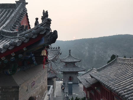 LUOYANG, CHINA - MARCH 20, 2017: view of people near Temples on East Hill of Chinese Buddhist monument Longmen Grottoes in spring. The complex was inscribed upon the UNESCO World Heritage List in 2000のeditorial素材
