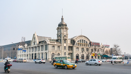 BEIJING, CHINA - MARCH 19, 2017: cars on square and Zhengyangmen East Railway Station, part of the China Railway Museum on Qianmen street. This building was opened as Beijing Railway Museum in 2008のeditorial素材