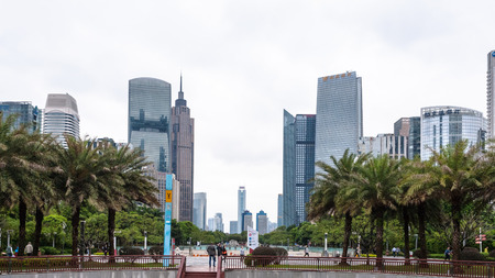 GUANGZHOU, CHINA - MARCH 31, 2017: tourists on square in Zhujiang New Town of Guangzhou city in spring rainy day. Guangzhou is the third most-populous city in China with population about 13,5 mlnのeditorial素材
