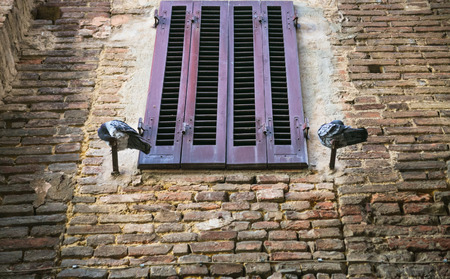 travel to Italy - pigeons near closed window of medieval house in Siena city in winterの写真素材